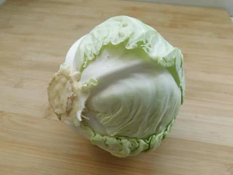 A head of fresh white cabbage on the table. Stock Photos
