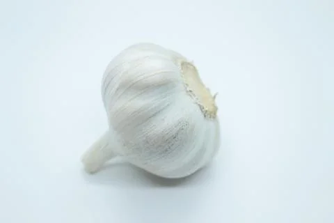 The head of garlic is located on a white background Stock Photos