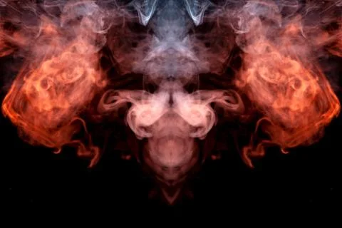 The head of a ghost on a black background from a smoke pattern of an orange-c Stock Photos