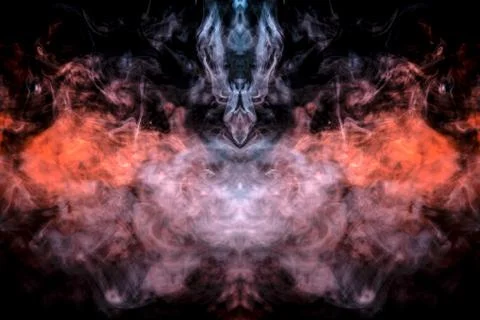 The head of a ghost on a black background from a smoke pattern of an orange-c 写真素材