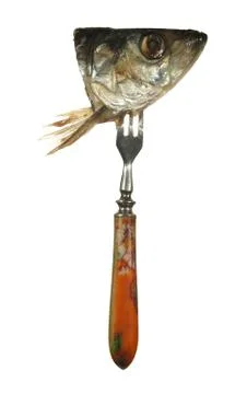 Head herring on old fork with a colored pen, isolated on white background. Stock Photos
