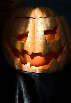 Head of a Jack-o-lantern pumpkin on a black background with copy space. Stock Photos