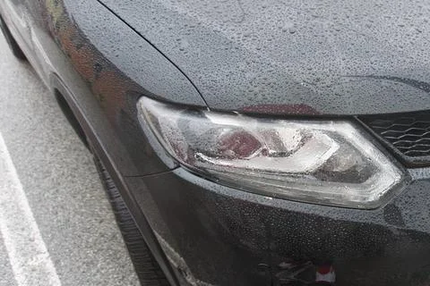 Head light of a car under rain Stock Photos