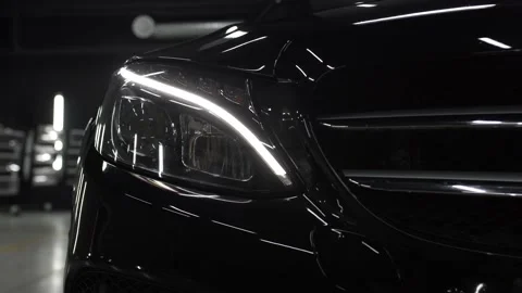 Head light. Close up of details of headlights of anonymous prestigious black Stock Footage 139636437