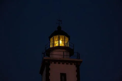The head of lighthouse at night. Stock Photos