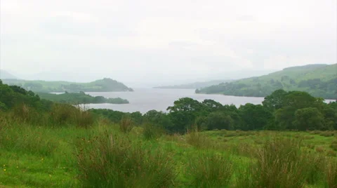 Head of a loch with low slopes and plenty of vegetation Stock Footage 39654378
