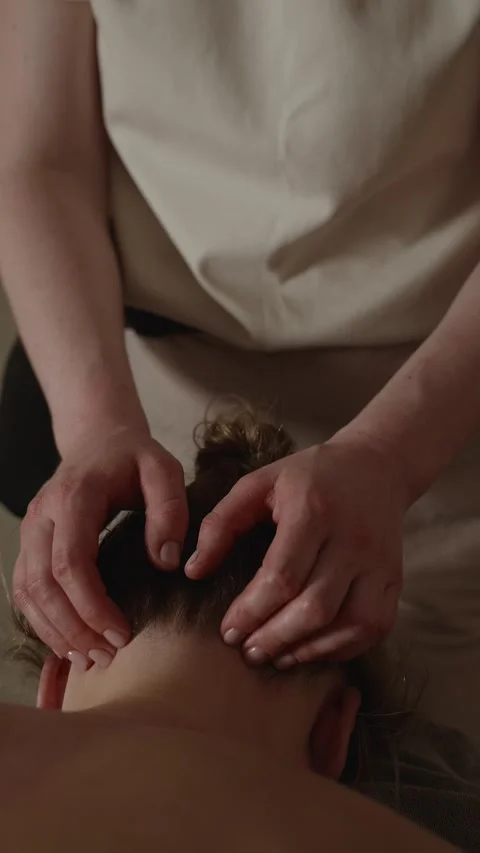 Head massage session in a quiet room with focus on relaxation and comfort Stock Footage 341280937