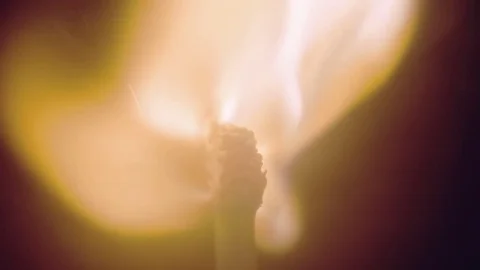 Head matches is lit a bright flame. Macro Stock Footage 82717009