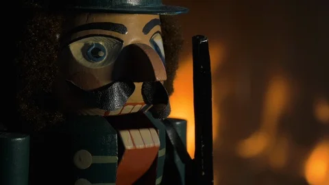 Head of an Nutcracker Figurine in Front of Flames Stock Footage 92686022