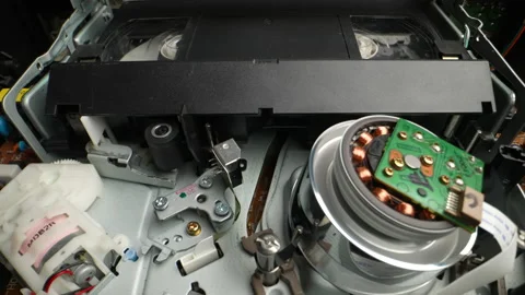 The head of an old VHS VCR with a VHS cassette. Dolly shot. Close-up Video stock 236850881