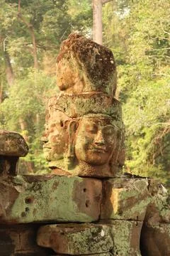 The head of one of the stone statues lined up on the bridge leading to the .. Stock Photos