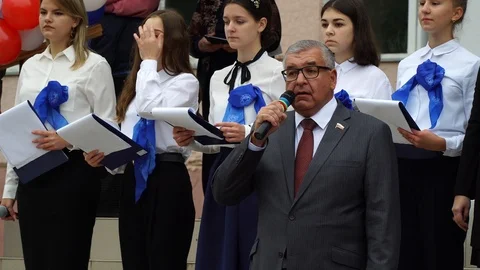 Head of school congratulates elementary school students on their first day of Stock Footage 120909467