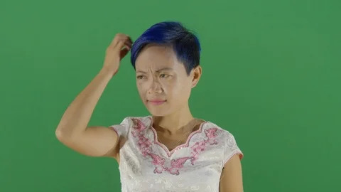 Head scratching by a woman like unable to solve a problem or in front of a Stock-Footage 126308267