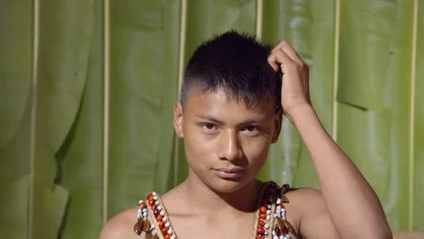 Head scratching by a young boy like unable to solve a problem or in front of a Stock-Footage 113216571