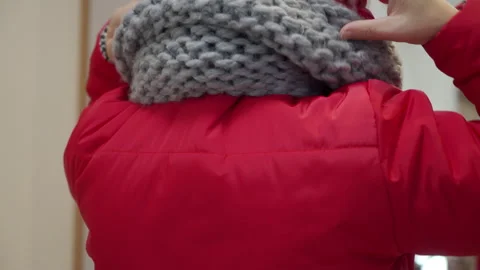 Head Secured: Red Jacket Hood Pulled Up Over Scarf with a Soft Swishing Noise Video stock 320809041