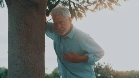 Head shot close up portrait sick old man feeling bad touching his chest at .. Stock Footage 229818157