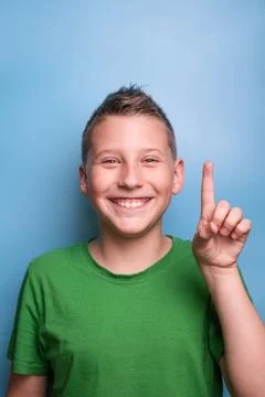 Head shot of emotional adorable boy in green t-shirt Stock Photos
