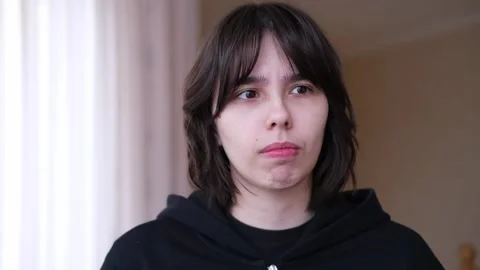 Head shot front view of upset worried young brunette woman, thinking of problems Stock Footage 261192286
