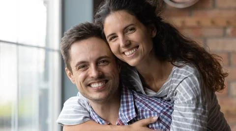 Head shot portrait of smiling beautiful loving sincere family couple. Stock Photos