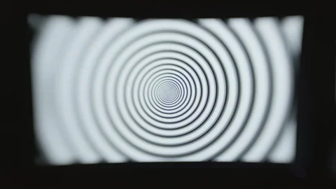 Head on shot of a single computer screen with a hypnotic spiral pattern Stock Footage 273039346