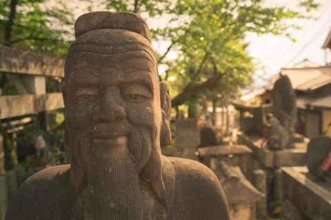 Head shot of a wise man stone statue in Asian style. Statue in Buddhist Stock Photos