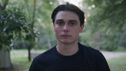 Head Shot of a Young Man Outdoors Stock Footage 208792603