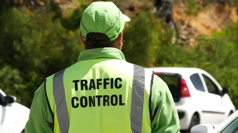 Head shoulders of traffic control person,  man leans into frame to speak Vídeo Stock 80705043