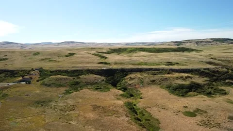 Head-Smashed-In Buffalo Jump near Alberta's rocky mountains, aerial Stock Footage 139948857