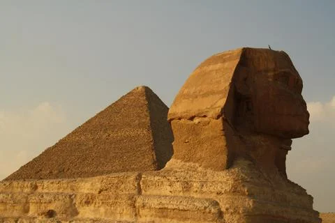 Head of the sphinx and Cheops pyramid Stock Photos