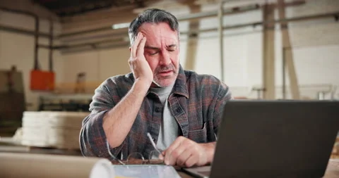 Headache, carpenter and laptop with man in workshop for fatigue, woodworking Stock Footage 338315903