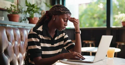 Headache, laptop and remote work with black woman in coffee shop for error or Stock Footage 330995951