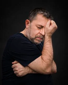Headache. man with face closed by hand Stock Photos