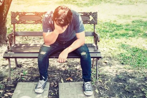 Headache man sitting on bench. Stock Photos