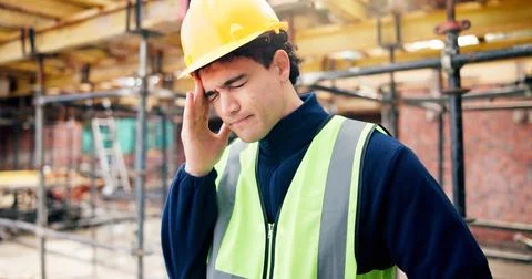 Headache, stress and construction worker on site with fatigue, burnout or Stock Photos