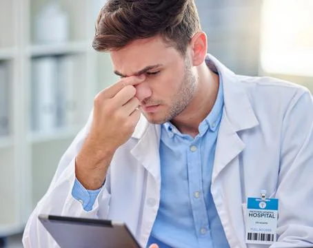 Headache, stress and tired doctor on tablet with anxiety, pain or overworked for Stock Photos