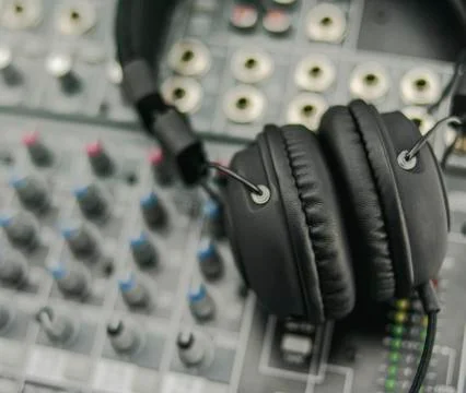 Headband headphones on a mixer with knobs and inserts Stock Photos