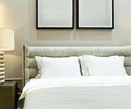Headboard of bed with pillows close-up. Stock Photos