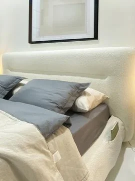 Headboard of bed with pillows close-up. Stock Photos
