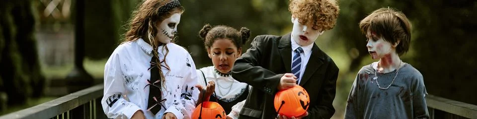 Header of Multiethnic Group of Children Trick or Treating during Halloween Stock Photos