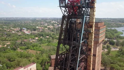 Headframe. Iron ore mining in the city center. Red mine in the industrial city.  Stock Footage 196396344