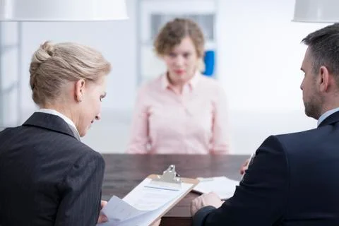 Headhunters looking at candidate references Stock-Fotos