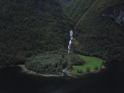 Heading Directly Towards a Waterfall descending from Steep Cliffs Stock Footage 80990775