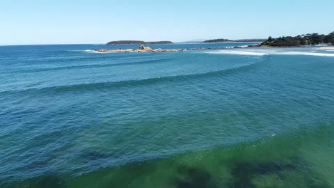 Heading out to sea over rolling waves and rock outcrops Video stock 134127947