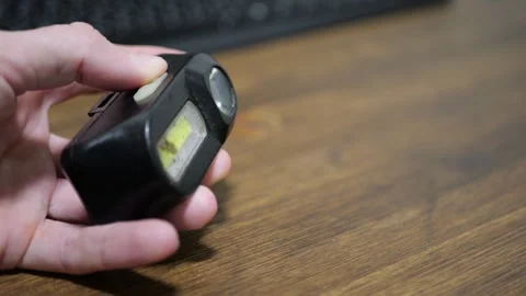 Headlamp in Hand with Finger Pressing Button Triggering Cool White Light and Stock Footage 321528317