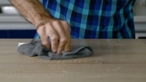 Headless torso of a man cleaning the table of leftover flour Stock Footage 128823632