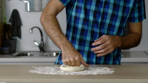 Headless torso of a man kneading a small loaf of bread Stock Footage 128820549