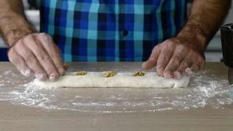 Headless torso of a man making a small loaf of bread with nuts Stock Footage 128823658