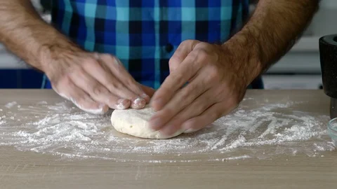 Headless torso of a man making a small loaf of bread with nuts Stock Footage 128824040