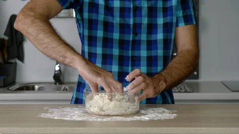 Headless torso of a man mixing preparing flour dough Stock Footage 128821911