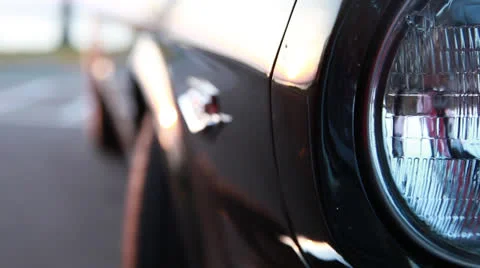 Headlight and side of Mustang a, rackfocus series (with bikes) Stock Footage 23827896